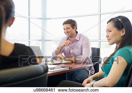 Stock Image - Business executives at brainstorming meeting. Fotosearch