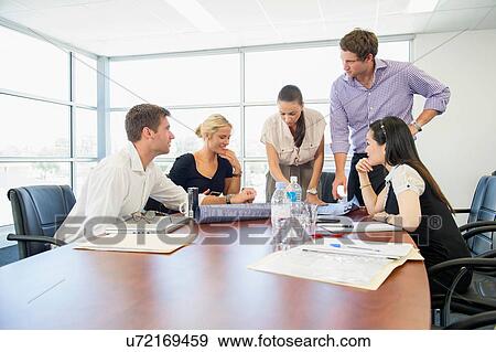 Stock Photo - Business executives at brainstorming meeting. Fotosearch