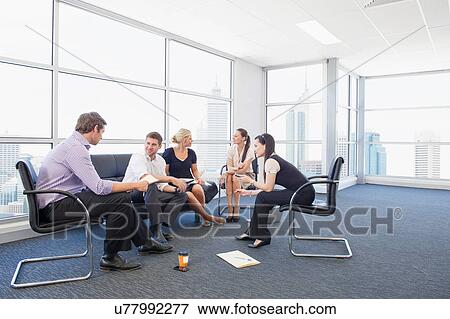 Stock Photo - Business executives at brainstorming meeting. Fotosearch
