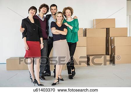 Businesspeople standing in front of pile of cardboard boxes View Large Photo Image Stock Image - Businesspeople standing in front of pile of cardboard boxes. Fotosearch