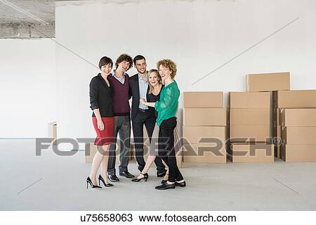 Businesspeople standing in front of pile of cardboard boxes View Large Photo Image Stock Image - Businesspeople standing in front of pile of cardboard boxes. Fotosearch