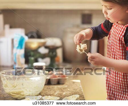 Child holding spoon with cake mix View Large Photo Image Stock Photo - Child holding spoon with cake mix. Fotosearch