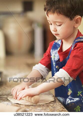 Child kneading dough with rolling pin View Large Photo Image Stock Image - Child kneading dough with rolling pin. Fotosearch