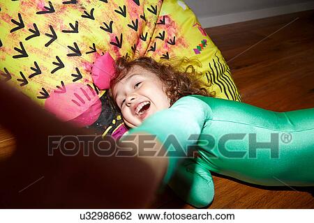 Child on bean bag on floor View Large Photo Image Stock Image - Child on bean bag on floor. Fotosearch