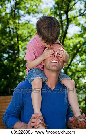 Child riding piggy back on father View Large Photo Image Stock Photography - Child riding piggy back on father. Fotosearch