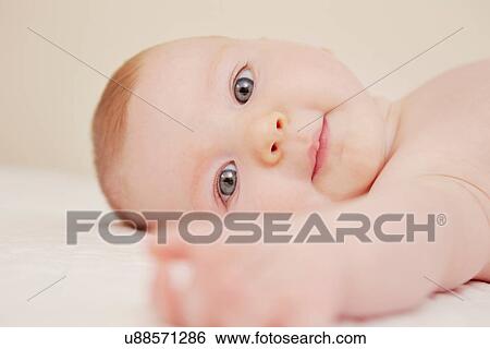 Stock Photograph - Close up of baby in crib playing. Fotosearch