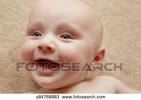 Stock Image - Close up of baby with wide smile. Fotosearch