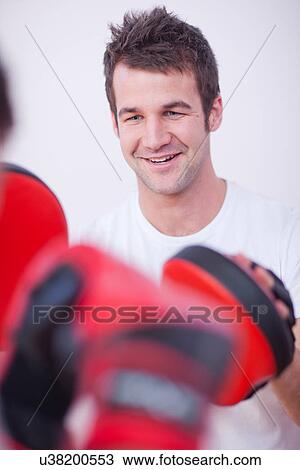 Stock Image - Close up of personal trainer in gym. Fotosearch