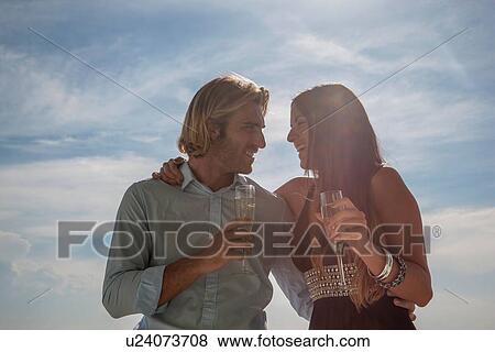 Stock Photo - Couple celebrating with champagne. Fotosearch