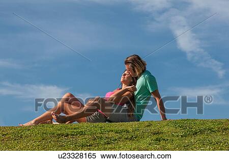 Couple embracing on meadows View Large Photo Image Stock Photography - Couple embracing on meadows. Fotosearch
