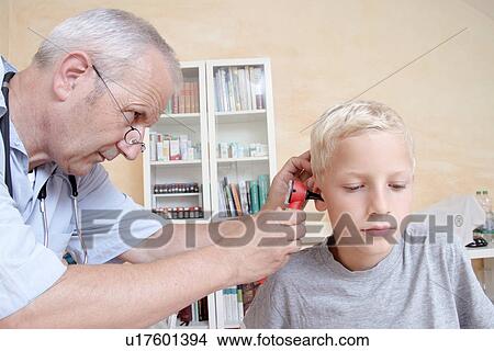 Picture - Doctor examining boy's ear. Fotosearch