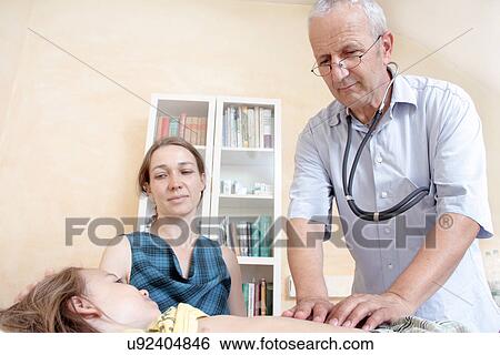 Stock Photograph - Doctor examining girl. Fotosearch