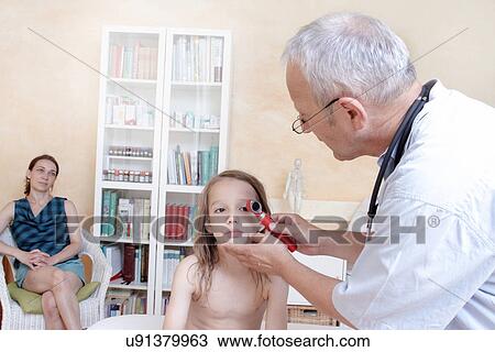 Doctor examining girl's eyes View Large Photo Image Stock Image - Doctor examining girl's eyes. Fotosearch
