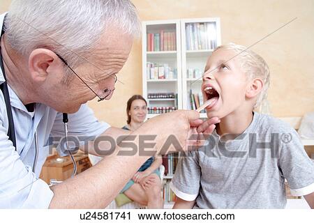 Doctor looking in boy's mouth View Large Photo Image Stock Image - Doctor looking in boy's mouth. Fotosearch