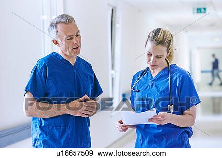 Stock Photo - Doctors looking at medical records. Fotosearch