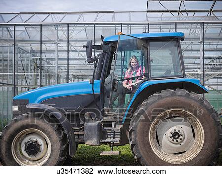 Female farmer in tractor on herb farm View Large Photo Image Stock Image - Female farmer in tractor on herb farm. Fotosearch