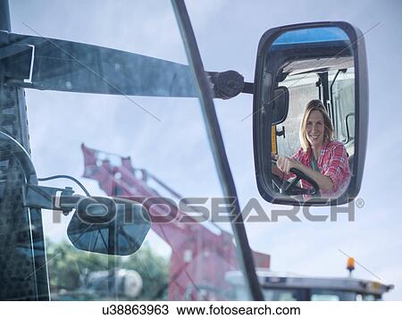 Female farmer's reflection in rearview mirror View Large Photo Image Stock Image - Female farmer's reflection in rearview mirror. Fotosearch
