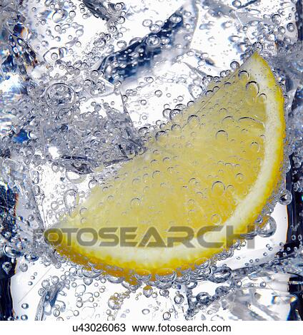 Fizzy lemon juice with ice cubes View Large Photo Image Stock Image - Fizzy lemon juice with ice cubes. Fotosearch