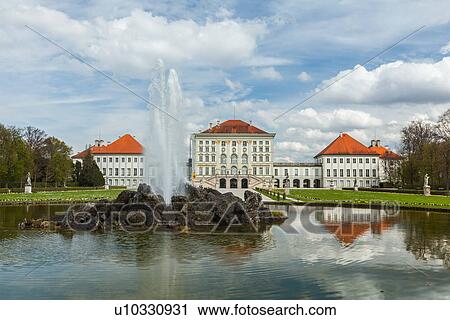 Stock Image - Fountain in the Grand Parterre (Baroque garden) and the rear view of the Nymphenburg Palace, Munich, Bavaria, Germany. Fotosearch