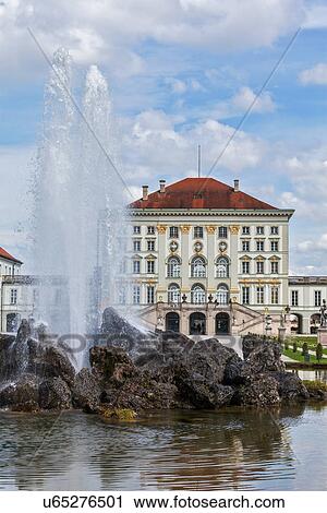 Stock Image - Fountain in the Grand Parterre (Baroque garden) and the rear view of the Nymphenburg Palace, Munich, Bavaria, Germany. Fotosearch