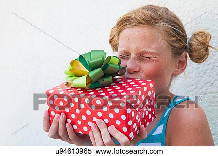 Girl kissing gift in hand View Large Photo Image Stock Photography - Girl kissing gift in hand. Fotosearch