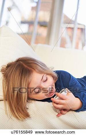 Girl on sofa using smartphone View Large Photo Image Stock Photo - Girl on sofa using smartphone. Fotosearch