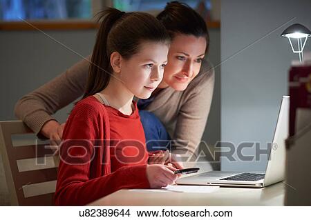 Picture - Girl using laptop computer. Fotosearch