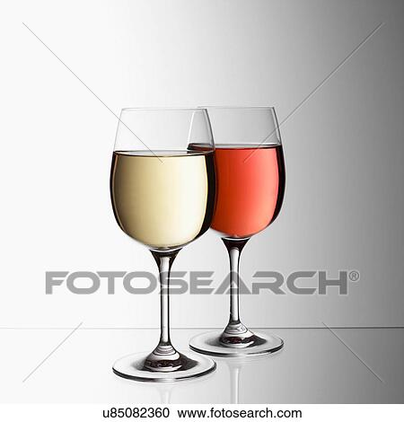 Stock Image - Glasses of white and rose wine. Fotosearch