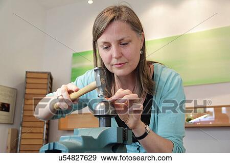 Goldsmith using hammer in workshop View Large Photo Image Stock Photo - Goldsmith using hammer in workshop. Fotosearch