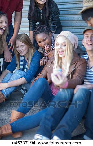 Picture - Group of teenagers fooling about. Fotosearch