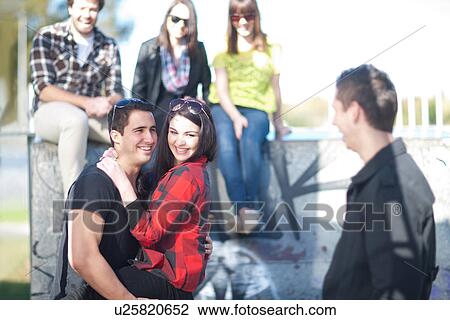 Group of young adult friends fooling about View Large Photo Image Stock Image - Group of young adult friends fooling about. Fotosearch