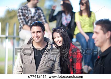 Group of young adult friends outdoors View Large Photo Image Stock Image - Group of young adult friends outdoors. Fotosearch