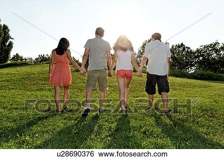 Group of young adults walking and holding hands View Large Photo Image Stock Photograph - Group of young adults walking and holding hands. Fotosearch