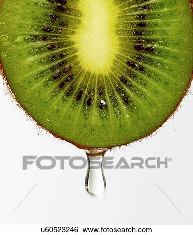 Stock Photograph - Juice dripping from kiwi. Fotosearch