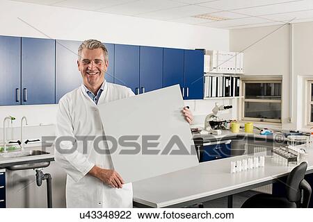Male scientist in laboratory with blank sign View Large Photo Image Stock Image - Male scientist in laboratory with blank sign. Fotosearch