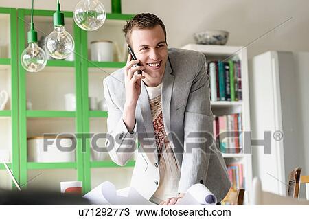 Stock Image - Man listening to mobile phone. Fotosearch