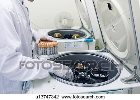 Man putting vials into centrifuge View Large Photo Image Stock Image - Man putting vials into centrifuge. Fotosearch