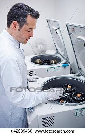 Man putting vials into centrifuge View Large Photo Image Stock Image - Man putting vials into centrifuge. Fotosearch