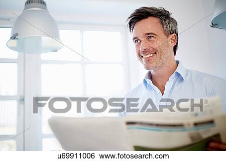 Man reading newspaper View Large Photo Image Stock Photograph - Man reading newspaper. Fotosearch