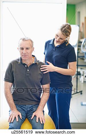 Man sitting on exercise ball View Large Photo Image Stock Photo - Man sitting on exercise ball. Fotosearch