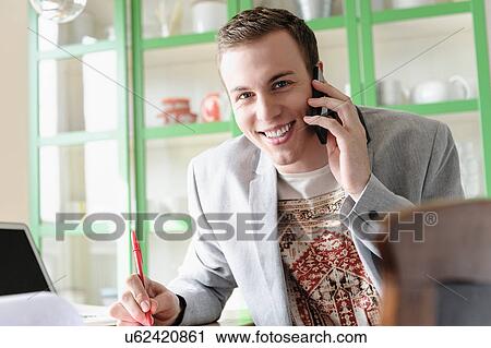 Man smiling and listening to mobile phone View Large Photo Image Stock Image - Man smiling and listening to mobile phone. Fotosearch
