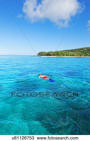 Stock Image - Man snorkelling, Drawaqa Island, Yasawa island group, Fiji, South Pacific. Fotosearch