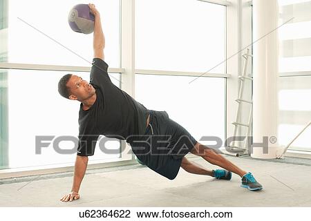 Man stretching using exercise ball View Large Photo Image Stock Image - Man stretching using exercise ball. Fotosearch