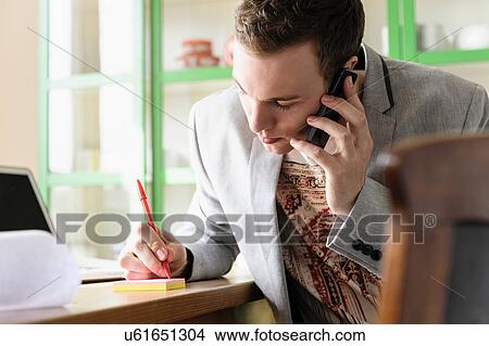 Man taking phone message View Large Photo Image Picture - Man taking phone message. Fotosearch