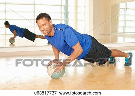 Man using exercise ball View Large Photo Image Stock Photo - Man using exercise ball. Fotosearch