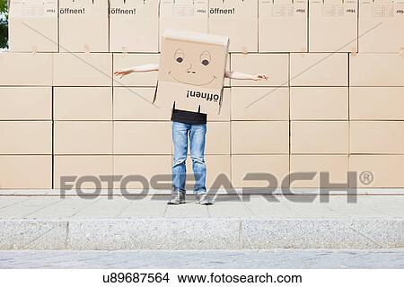 Picture - Man wearing cardboard box covering his head. Fotosearch