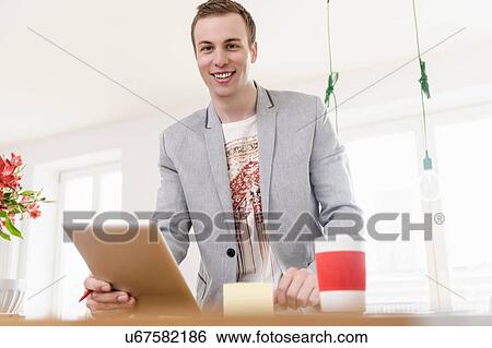 Man with digital tablet smiling View Large Photo Image Stock Photograph - Man with digital tablet smiling. Fotosearch