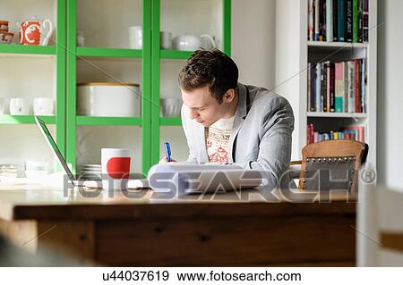 Man writing at desk View Large Photo Image Stock Photo - Man writing at desk. Fotosearch