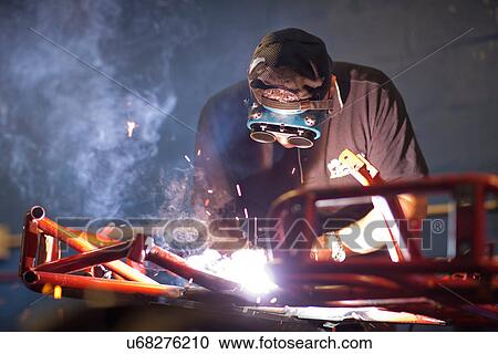 Mechanic welding go cart in workshop View Large Photo Image Stock Image - Mechanic welding go cart in workshop. Fotosearch