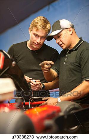 Mechanics in workshop repairing go cart View Large Photo Image Stock Image - Mechanics in workshop repairing go cart. Fotosearch